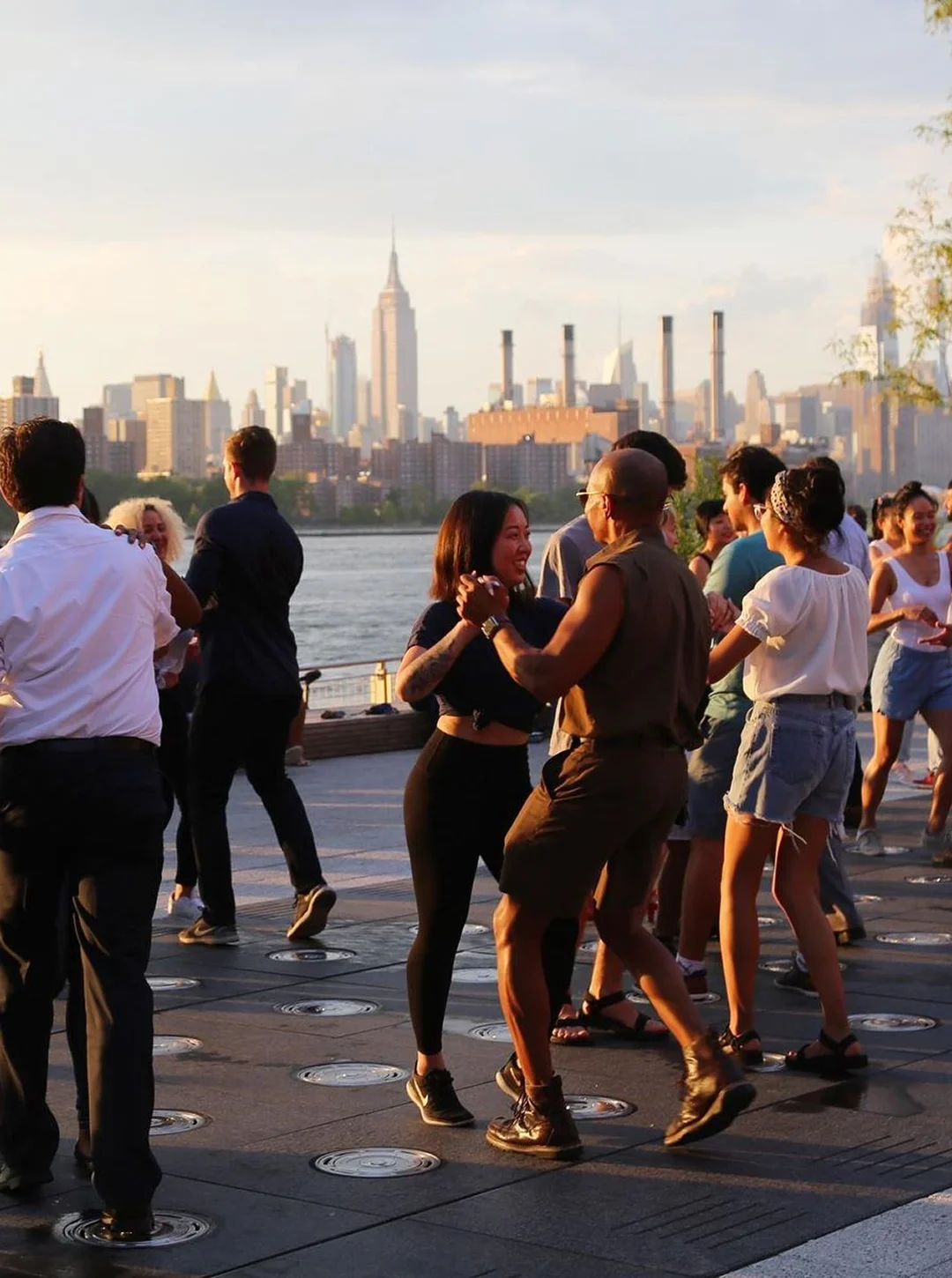 Gente bailando en una kedada al atardecer